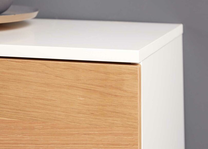 Zoom sur le bois et le corps blanc du buffet long