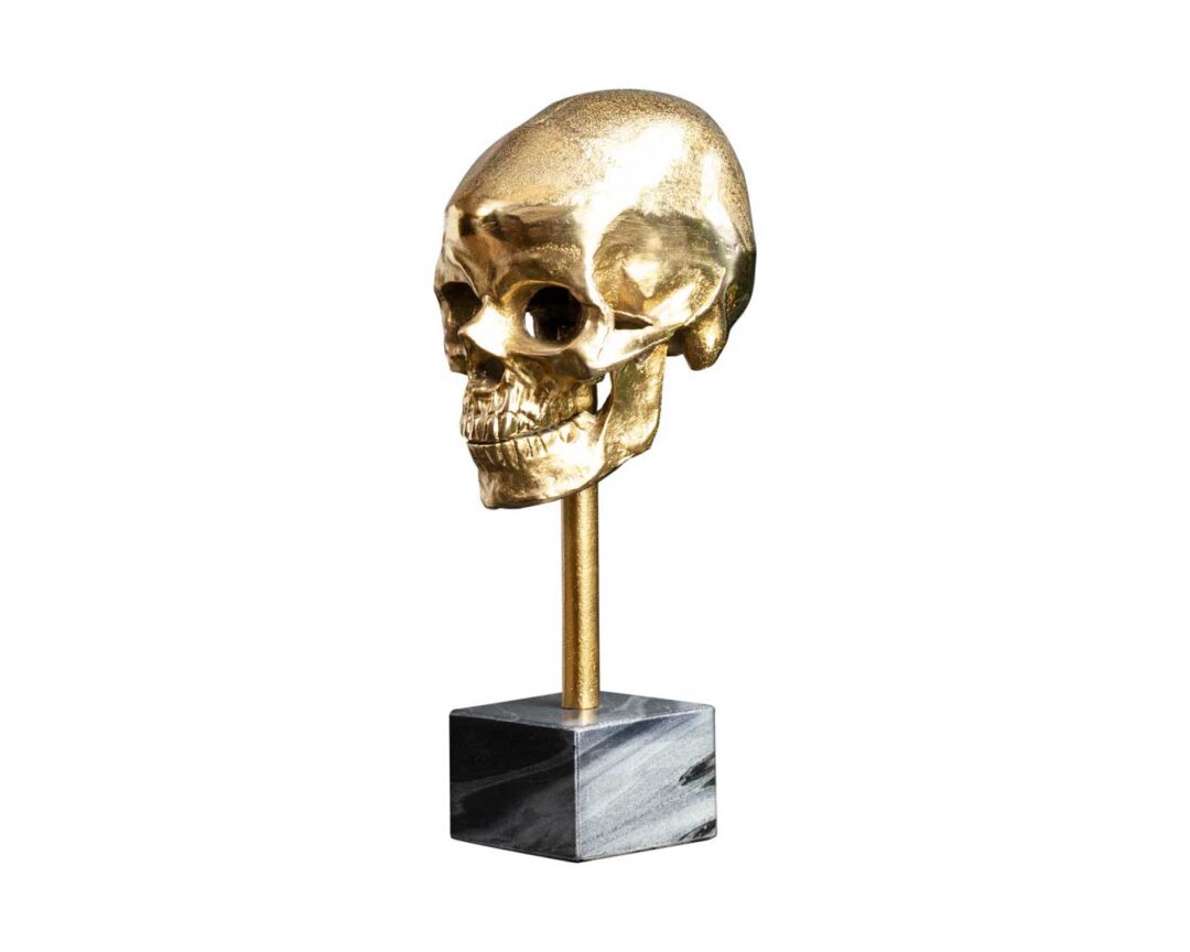 Décoration crâne doré sur socle en marbre