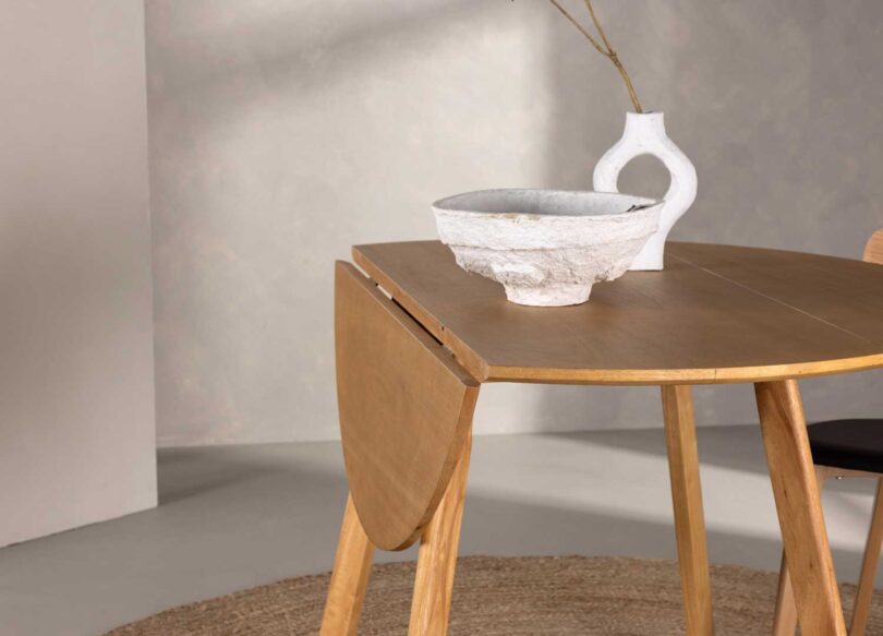 Allonge pliée de la table de repas ronde aspect bois