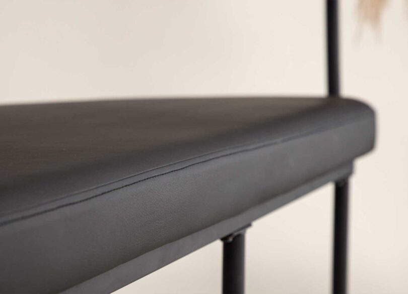 Assise en simili cuir noir de la banquette de salon salle à manger