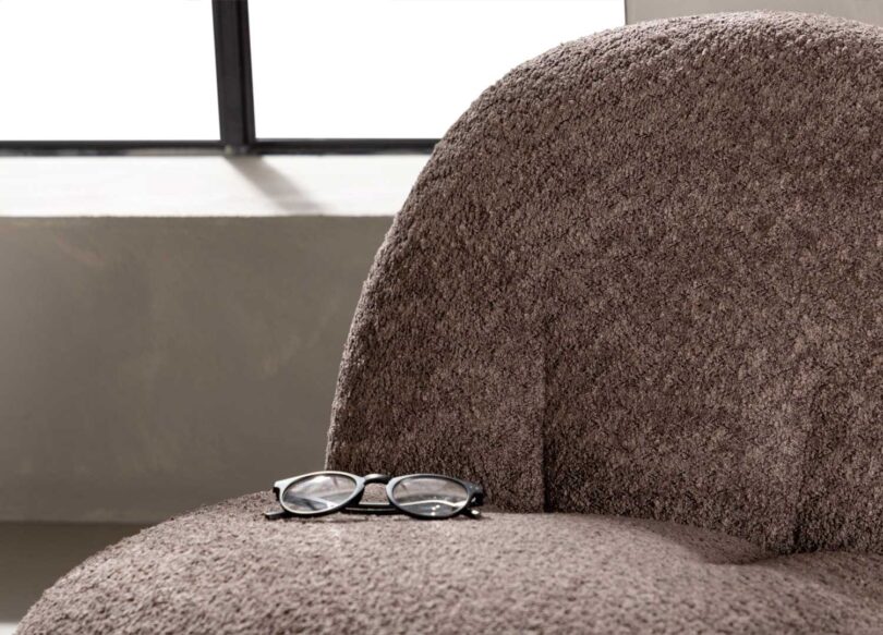 Zoom sur le tissu brun du fauteuil design moderne