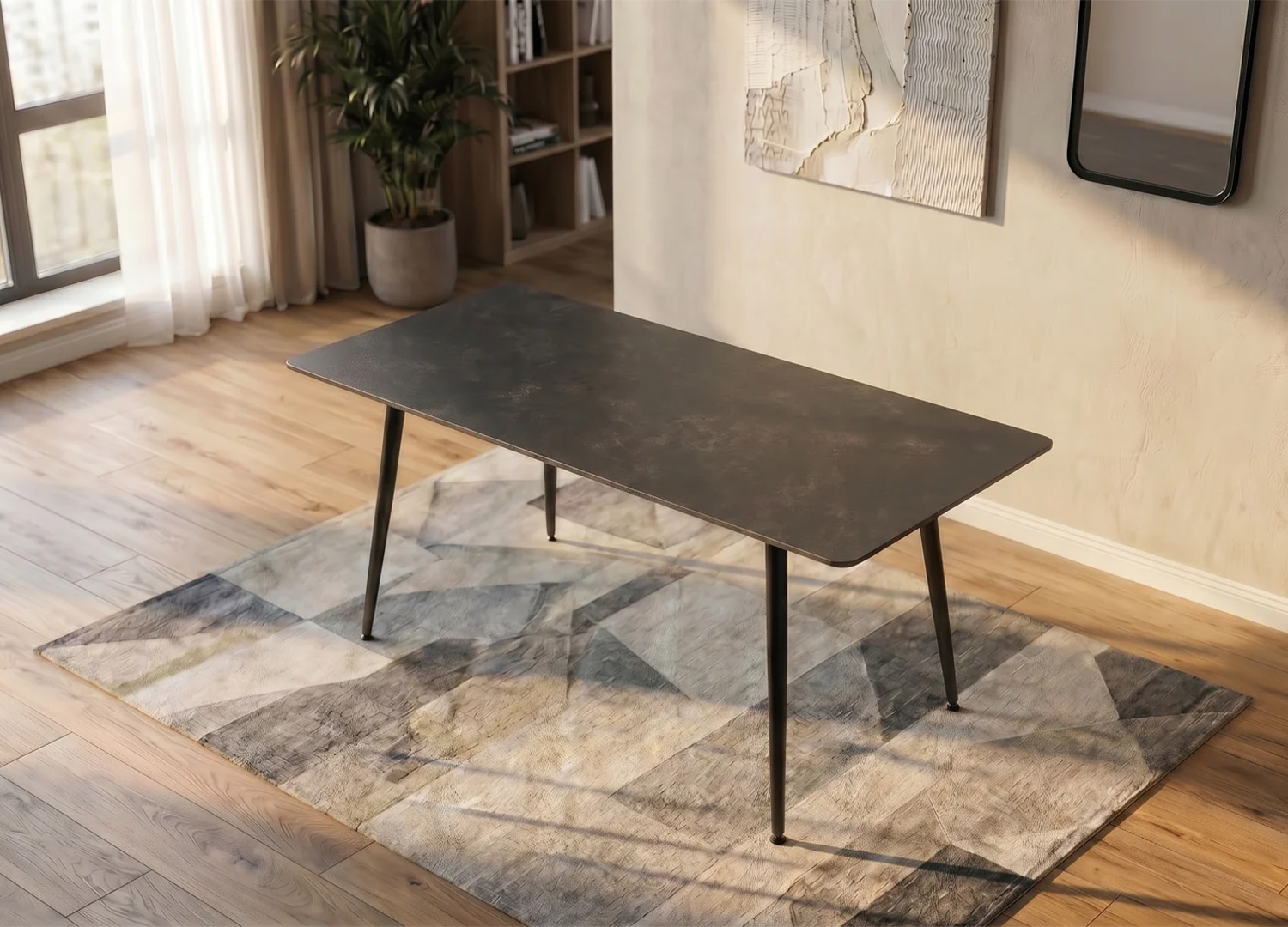 Table à manger KAVEN 140 cm en céramique anthracite dans une salle à manger moderne avec tapis graphique