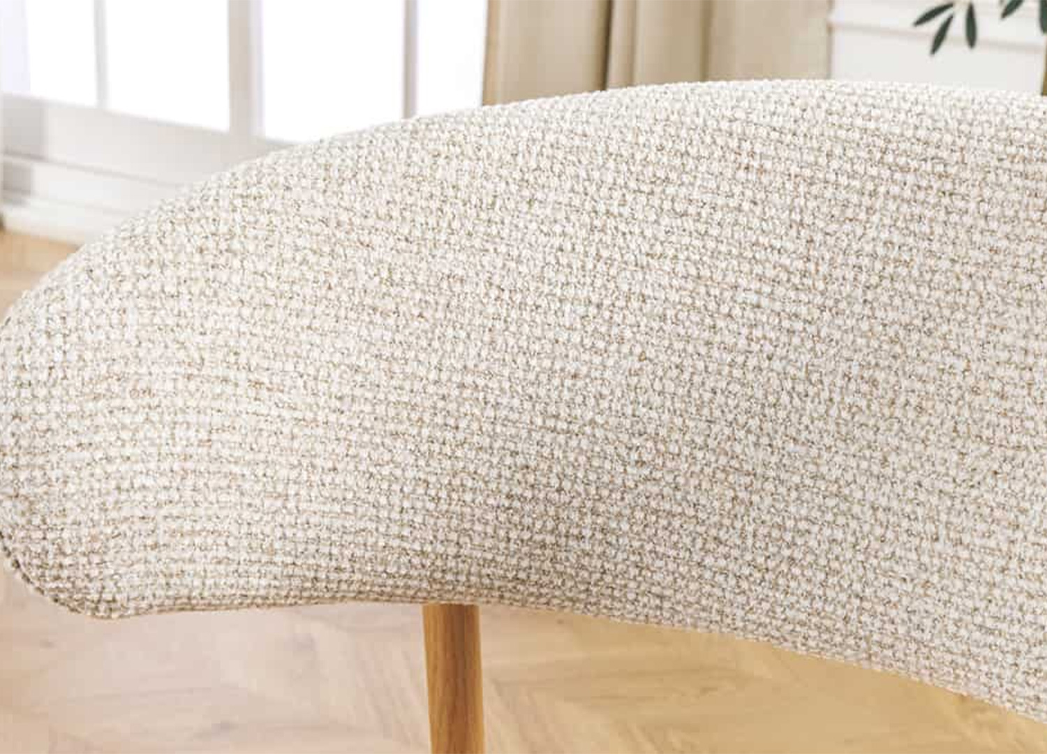 Gros plan sur la texture du dossier beige de la chaise de salle à manger ALBANE
